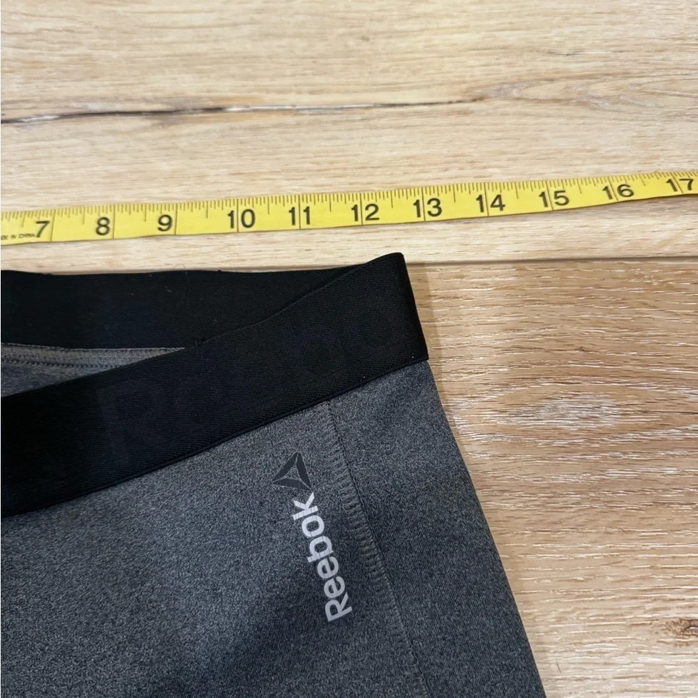 Reebok charcoal gray athletic leggings, mesh patterned detailing on side, S.